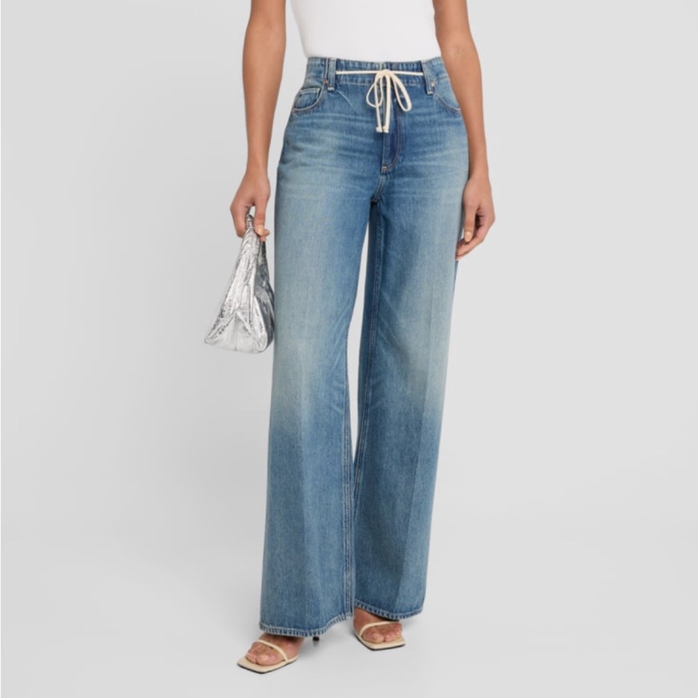 PAIGE "Zoey" jeans featuring a tie waist in faded medium-wash denim